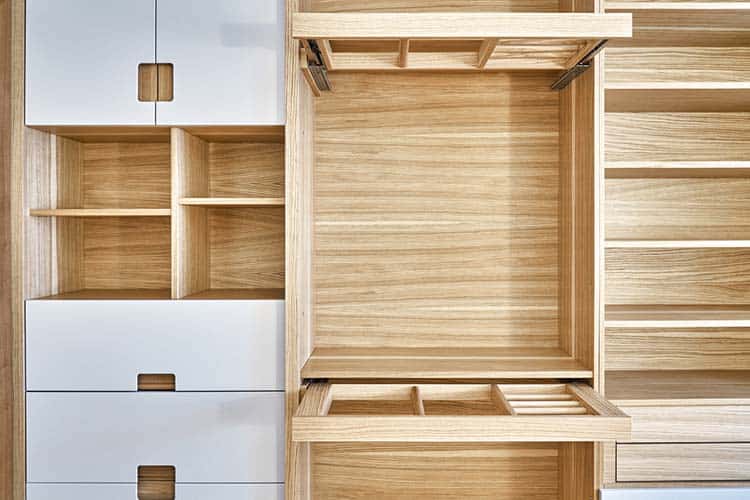 Modern wardrobe with slide out rack for coathangers. Detail of modern furniture